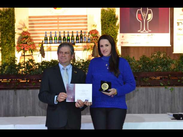 Rosane Cappelletti, da Vinícola Cappelletti, empresa vencedora da Distinção Especial Moscatel Premium na categoria Espumante Moscatel, recebendo a premiação das mãos do presidente da Afavin, João Carlos Taffarel