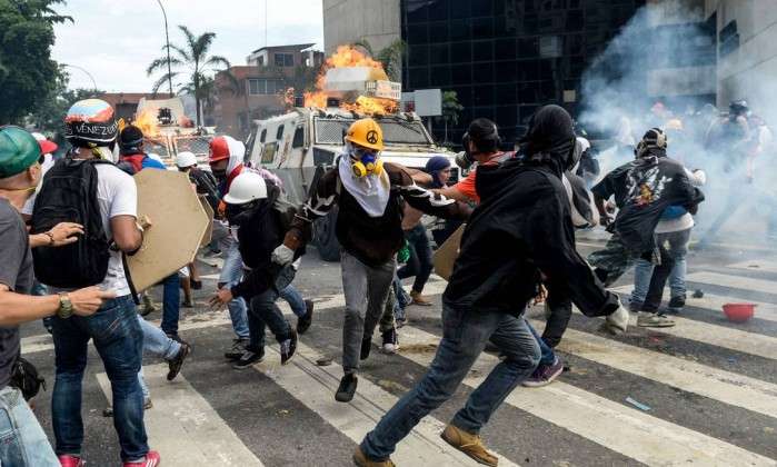 Manifestantes em confronto com tropas do governo em Caracas
